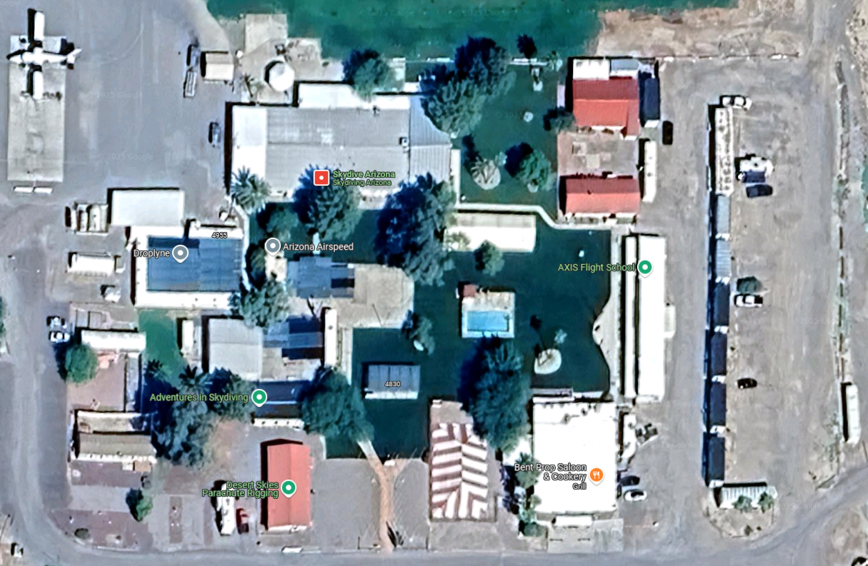Close-up satellite view of Skydive Arizona facilities showing Manifest, Arizona Airspeed, AXIS Flight School, Bent Prop Saloon, and more